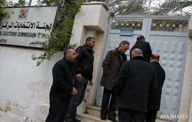 Palestinian members of Interior Ministry and the Central Elections Commission (CEC) members open the organization headquarters in Gaza city on Jan. 24,2012. The head of the regional office of the central elections commis...