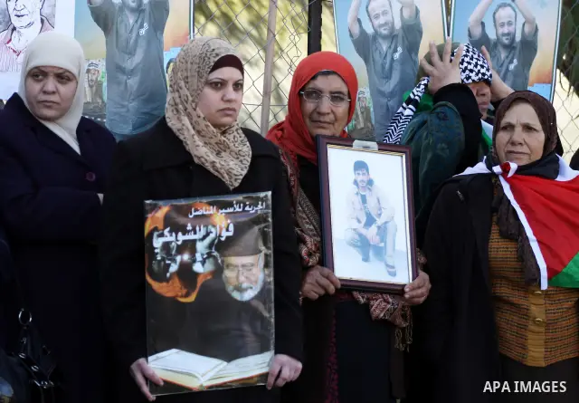Relatives of Palestinian prisoners held in Israeli jails protest in front the International Committee of the Red Cross (ICRC) offices in the West Bank town of Ramallah, 24 January 2012, during a protest organized by the...