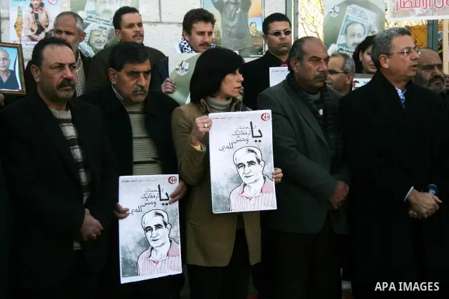 Relatives of Palestinian prisoners held in Israeli jails protest in front the International Committee of the Red Cross (ICRC) offices in the West Bank town of Ramallah, 24 January 2012, during a protest organized by the...