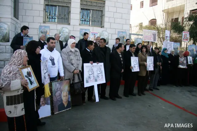 Relatives of Palestinian prisoners held in Israeli jails protest in front the International Committee of the Red Cross (ICRC) offices in the West Bank town of Ramallah, 24 January 2012, during a protest organized by the...