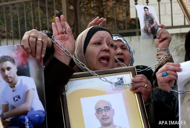 Palestinians participate in a demonstration calling for release of Palestinian prisoners held in the Israeli jails . in the West Bank city of Nablus, Jan. 25, 2012. Israel is currently holding thousands of Palestinians i...