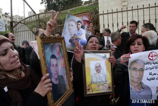 Palestinians participate in a demonstration calling for release of Palestinian prisoners held in the Israeli jails . in the West Bank city of Nablus, Jan. 25, 2012. Israel is currently holding thousands of Palestinians i...