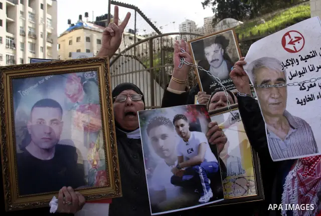 Palestinians participate in a demonstration calling for release of Palestinian prisoners held in the Israeli jails . in the West Bank city of Nablus, Jan. 25, 2012. Israel is currently holding thousands of Palestinians i...