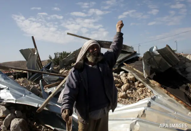 A Palestinian bedouin man reacts near his destroyed house in Oum al-Khair village southern West Bank city of Hebron after the house was destroyed by the Israeli army on January 25, 2012. Photo by Mamoun Wazwaz