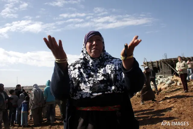 A Palestinian bedouin woman reacts near her destroyed house in Oum al-Khair village southern West Bank city of Hebron after the house was destroyed by the Israeli army on January 25, 2012. Photo by Mamoun Wazwaz