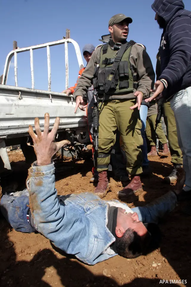 Palestinian bedouin scuffle with Israeli soldiers in Oum al-Khair village southern West Bank city of Hebron on January 25, 2012, after the Israeli army stopped building their house and confiscated the construction materi...