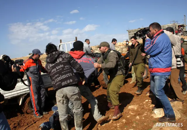 Palestinian bedouin scuffle with Israeli soldiers in Oum al-Khair village southern West Bank city of Hebron on January 25, 2012, after the Israeli army stopped building their house and confiscated the construction materi...