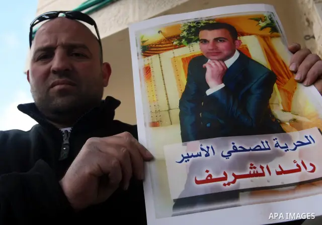 Palestinians participate in a demonstration calling for release of Journalist Raed Sharif, held in the Israeli jails . in the West Bank city of Hebron, Jan. 26, 2012. Israel is currently holding thousands of Palestinians...