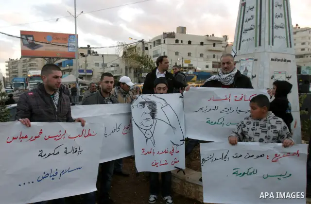 Palestinians demonstrate in Al-Azariya, on the outskirts of Jerusalem, to protest the high cost of living and against recent austerity measures announced by Palestinian prime minister Salam Fayyad (on poster) on January...