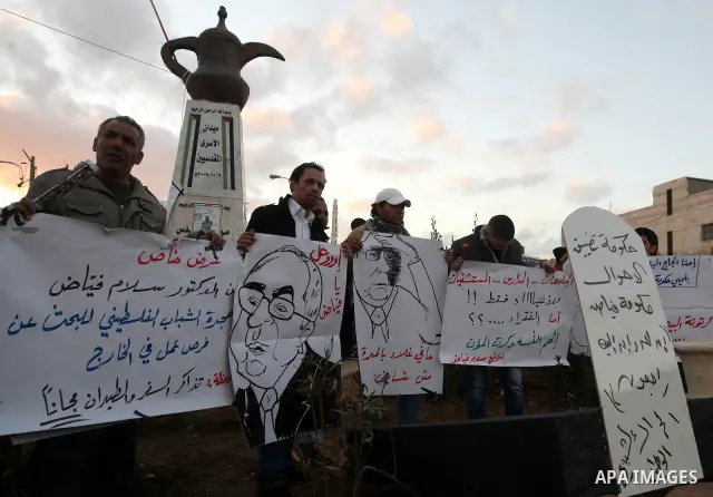Palestinians demonstrate in Al-Azariya, on the outskirts of Jerusalem, to protest the high cost of living and against recent austerity measures announced by Palestinian prime minister Salam Fayyad (on poster) on January...