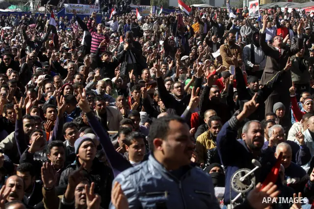 Egyptian demonstrators gather during a protest demanding the army to hand power to civilians at Tahrir square in Cairo on January 27, 2012, a year after a popular uprising. The protesters are demanding the implementation...