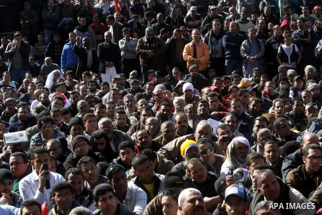 Egyptian demonstrators gather during a protest demanding the army to hand power to civilians at Tahrir square in Cairo on January 27, 2012, a year after a popular uprising. The protesters are demanding the implementation...