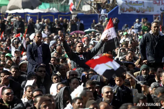 Egyptian demonstrators gather during a protest demanding the army to hand power to civilians at Tahrir square in Cairo on January 27, 2012, a year after a popular uprising. The protesters are demanding the implementation...