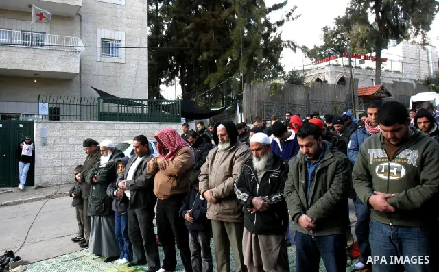.Palestinians attend Friday prayers outside the Red Cross offices during a protest in east Jerusalem on January 27, 2012 in support with four senior Hamas officials whom Israel has been seeking to expel, sparking concern...