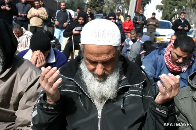 .Palestinians attend Friday prayers outside the Red Cross offices during a protest in east Jerusalem on January 27, 2012 in support with four senior Hamas officials whom Israel has been seeking to expel, sparking concern...