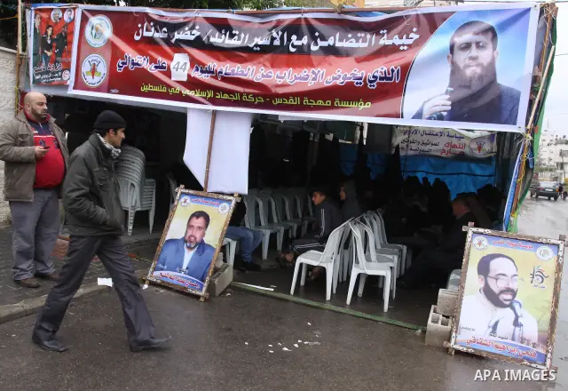 Palestinians hold pictures of their prisoned relatives in Israeli jails as they gather in a weekly activity calling for their liberty at the Red Cross headquarters in Gaza City, on Jan. 30, 2012. Photo by Mohammed Asad