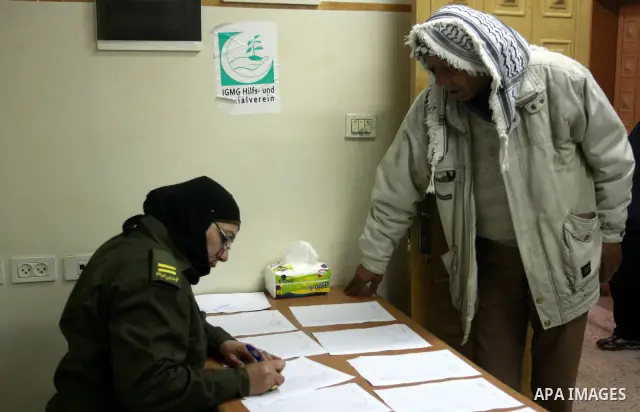 Palestinian National Security forces help patients during working day the medical camp in his court in the West Bank city of Nablus, Jan. 30, 2012. Photo by Wagdi Eshtayah.