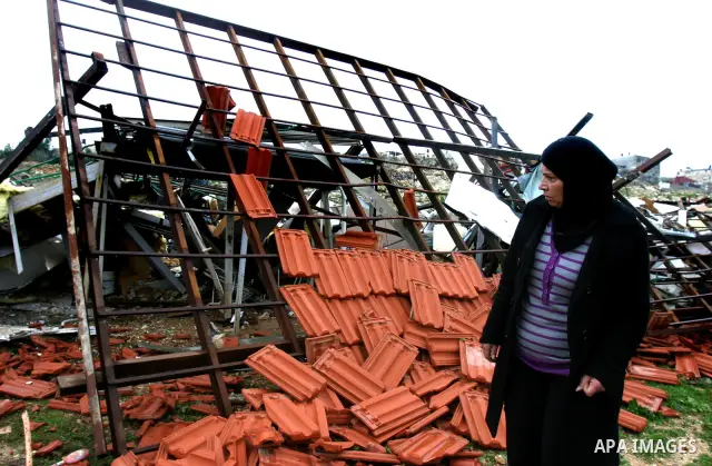 A Palestinian woman inspects the rubble of a home after it was demolished by Israeli bulldozers in the Arab east Jerusalem neighbourhood of Beit Hanina on January 30, 2012. Israel regularly demolishes homes in Arab east...