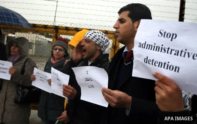 A Palestinian demonstrator shouts slogans during a protest in support of jailed Islamic Jihad spokesman Khodr Adnan outside Israel's Ofer prison near the West Bank town of Betunia on January 30, 2012. Adnan has been on h...