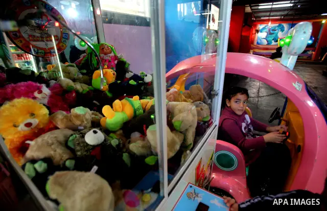 Palestinians children enjoy a ride in an amusement park, during School holidays in Gaza City, Jan. 30, 2012. Photo by Ashraf Amra
