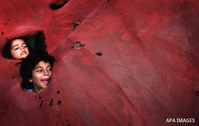 Palestinian children, from a Bedouin family, paly during low winter temperatures inside their family's tent in Gaza's Zeitoun neighbourhood January 31, 2012. Photo by Mahmud Nassar