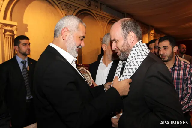 Palestinian Prime Minister in Gaza Strip, Ismail Haniyah receives released prisoners, deported to the Qatar, in the Qatari capital of Doha on Jan. 31,2012. photo by Mohammed Al-Ostaz