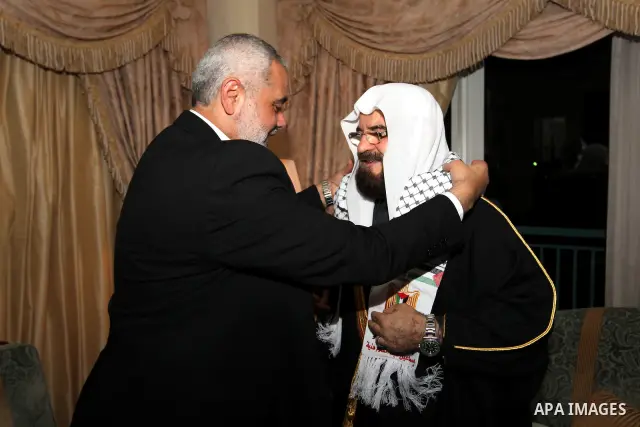 Palestinian Prime Minister in Gaza Strip, Ismail Haniyah meets with Secretary General of the International Union for Muslims Scholars Dr. Ali Mohi El-dein Qara Daghi in the Qatari capital of Doha on Jan. 31,2012. Photo b...
