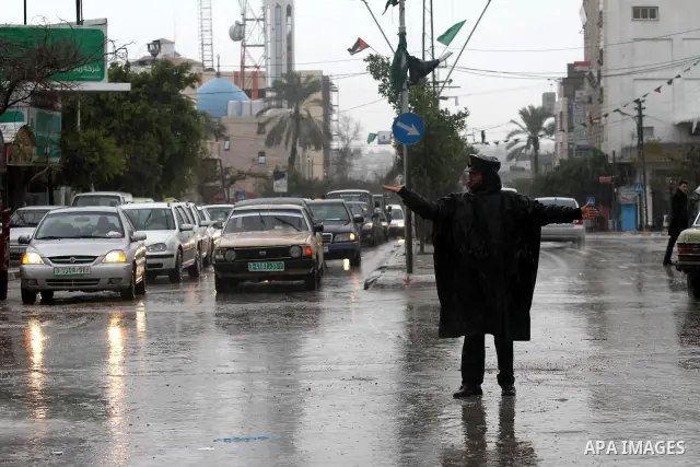 Palestinian policemen organize the traffic during the heavy rain of the winter, in the Gaza City, Feb. 01, 2012. Photo by Mohammed Asad