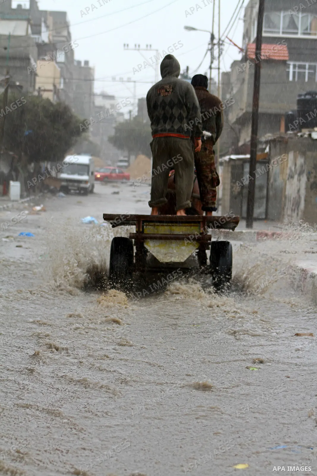 Palestinians walk in a street during the heavy rain of the winter, in the Gaza City, Feb. 01, 2012. Photo by Ashraf Amra