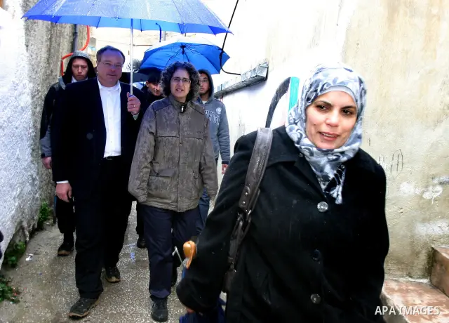 Germany's Minister for Economic Cooperation and Development Dirk Niebel speaks with a local dignitary during a visit to the Palestinian in silwan neighbourhood of jerusalem, on february 1, 2012. Photo by Mahfouz Abu Turk