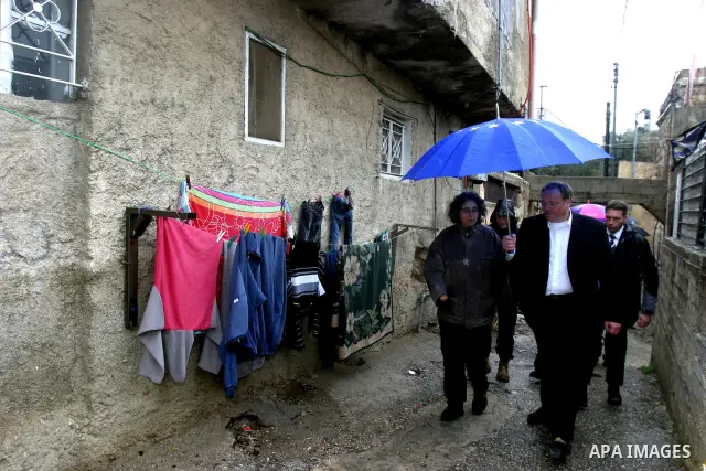 Germany's Minister for Economic Cooperation and Development Dirk Niebel speaks with a local dignitary during a visit to the Palestinian in silwan neighbourhood of jerusalem, on february 1, 2012. Photo by Mahfouz Abu Turk