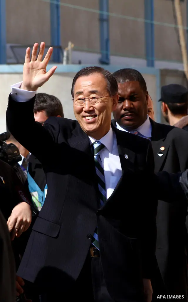 UN secretary general Ban Ki-moon waves during a visit to the construction site of a housing project in Khan Yunis in the southern Gaza Strip on February 2, 2012. Protesters threw shoes, sand and small stones at the convo...