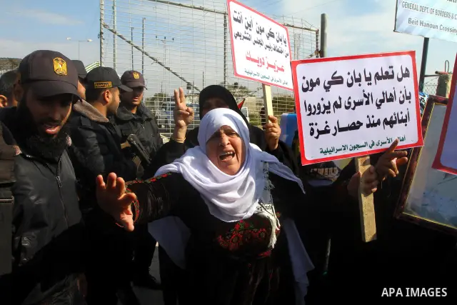 Palestinians demonstrate before the arrival of UN Secretary-General Ban Ki-moon at the Erez checkpoint in the northern Gaza Strip on February 2, 2012. Protesters threw shoes, sand and small stones at his convoy, which wa...