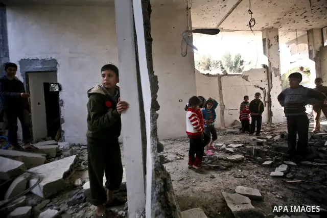 Palestian boys stand next to a destroyed house after an Israeli airstrike in Beit Lahiya town in the northern Gaza Strip, 03 February 2012. Two Palestinians were wounded by Israeli air-strikes in the Gaza Strip. . Photo...