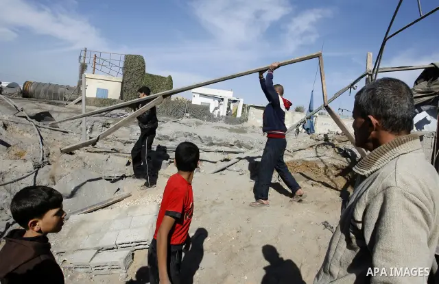 Palestinians survey the damage to a smuggling tunnel after it was targeted in an Israeli air strike in Rafah, in the southern Gaza Strip on February 3, 2012. Two Palestinians in the Gaza Strip were wounded by Israeli air...