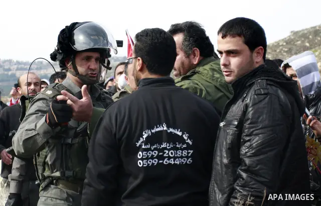 Israeli troops stop palestinian demonstrators during a protest in the Village Qaryut , near the Israeli settlement of Ali, in the northern West Bank, Friday, Feb. 03, 2012. Photo by Wagdi Eshtayah