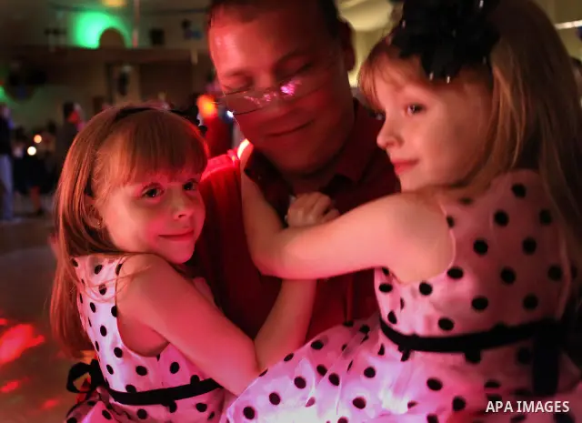 Feb. 3, 2012 - Brooksville, Fl - MAURICE RIVENBARK | Times.HT_349657_rive_DANCE.(02/03/2012, BROOKSVILLE) James Norris holds his 6 year-old twin daughters Dalaney and Nakayla (l-r in the photo) as the trio dance Friday n...