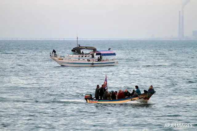 Palestinian men ride their boat near the beach during sunset ,in Gaza City on Feb. 04, 2012. Photo by Mohammed Asad