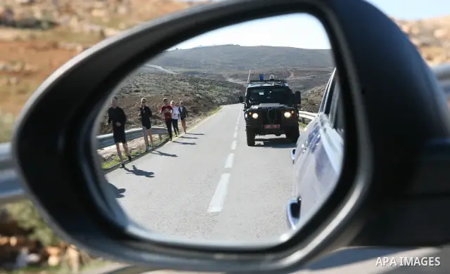 Israeli soldiers block the road in front of Palestinians, Israeli and foreign activists during a marathon to support the farmers and land owners in the West Bank city of Hebron on Feb. 4,2012. Israeli troops detained a P...