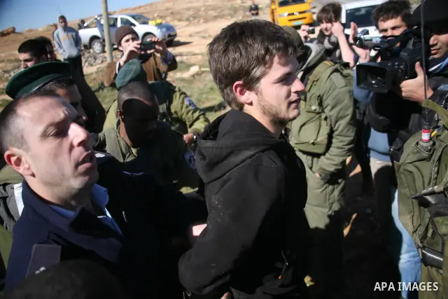 Israeli soldiers block the road in front of Palestinians, Israeli and foreign activists during a marathon to support the farmers and land owners in the West Bank city of Hebron on Feb. 4,2012. Israeli troops detained a P...