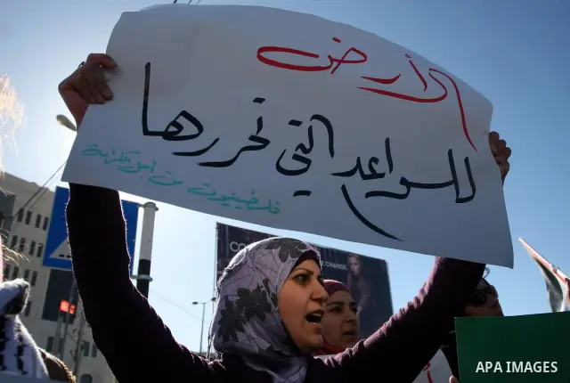 Palestinian activists hold banners during a protest against the peace talks in the West Bank city of Ramallah Saturday, February 4, 2012. Palestinian and Israeli negotiators met last week for the first time in more than...
