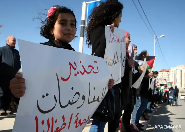 Palestinian activists hold banners during a protest against the peace talks in the West Bank city of Ramallah Saturday, February 4, 2012. Palestinian and Israeli negotiators met last week for the first time in more than...