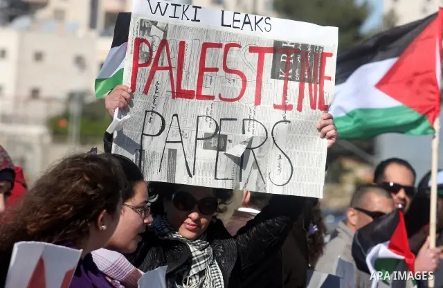Palestinian activists hold banners during a protest against the peace talks in the West Bank city of Ramallah Saturday, February 4, 2012. Palestinian and Israeli negotiators met last week for the first time in more than...