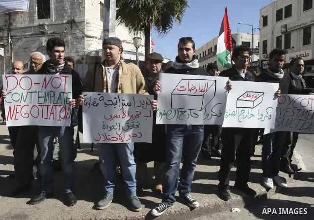 Palestinian activists hold banners during a protest against the peace talks in the West Bank city of Nablus, Saturday, February 4, 2012. Palestinian and Israeli negotiators met last week for the first time in more than a...