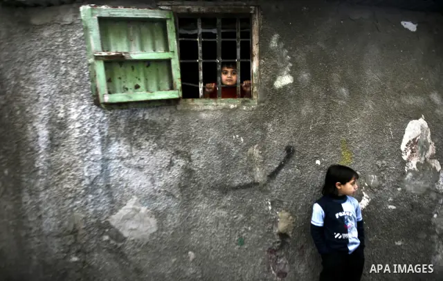 Palestinian refugee girl stands in front of her house in the Jabaliya refugee camp in the northern area of the Gaza Strip on 05 February 2012. Photo by Ali Jadallah