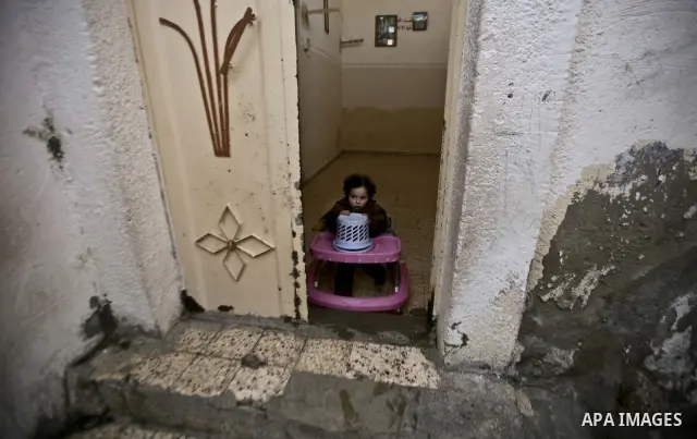 Palestinian refugee girl stands in front of her house in the Jabaliya refugee camp in the northern area of the Gaza Strip on 05 February 2012. Photo by Ali Jadallah