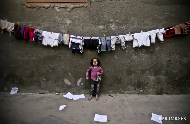 Palestinian refugee girl stands in front of her house in the Jabaliya refugee camp in the northern area of the Gaza Strip on 05 February 2012. Photo by Ali Jadallah