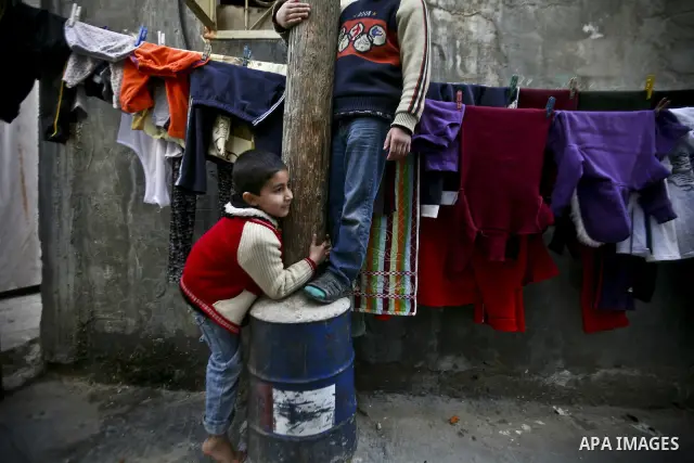 Palestinian refugeechildren stand in front of her house in the Jabaliya refugee camp in the northern area of the Gaza Strip on 05 February 2012. Photo by Ali Jadallah