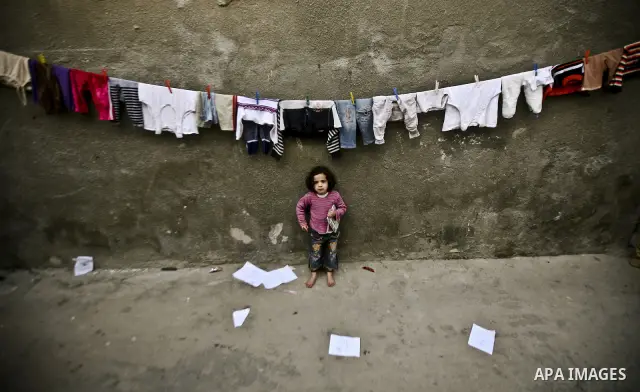 Palestinian refugee girl stands in front of her house in the Jabaliya refugee camp in the northern area of the Gaza Strip on 05 February 2012. Photo by Ali Jadallah