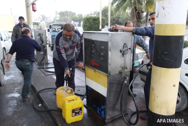 Palestinians wait to fill petrol in containers at a petrol station as a response to the rising price of gasoline in Gaza Strip, on Feb. 06, 2012. Photo by Mohammed Asad